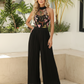 SOLACE  Black Floral Embroidered Mesh Halter Neck Pleated Wide Leg Jumpsuit?